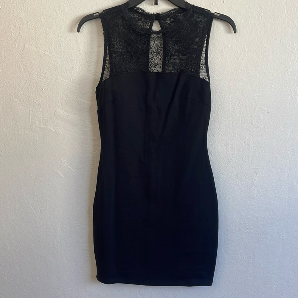 Solemio brand. Women’s bodycon style dress, solid black with lace neckline.